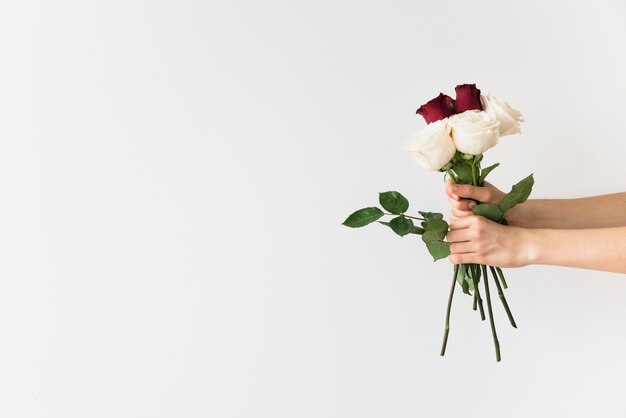 Wedding concept with hands holding bouquet