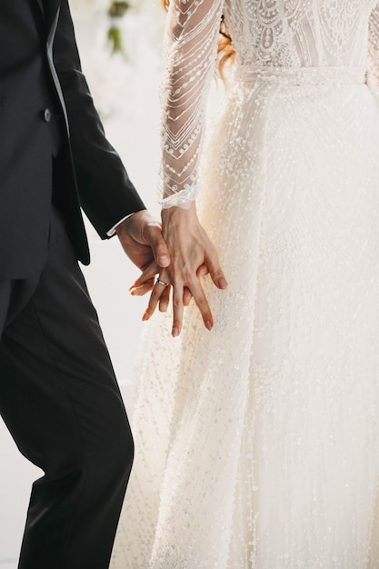 Free photo wedding couple hold hands