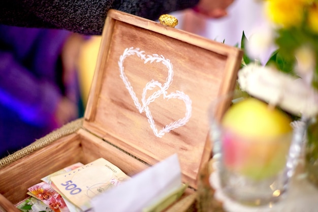 Wedding decor. Wooden chest with printed white hearts