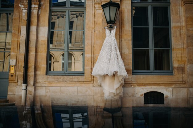 Wedding dress hanging on the street lamp