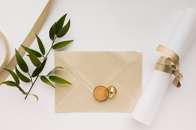 wedding invitation and engagement rings on table