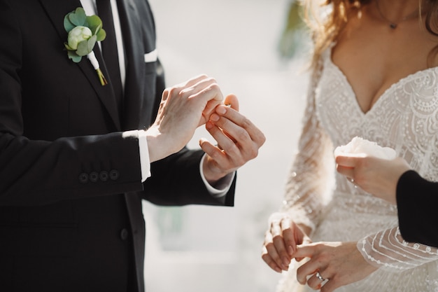 Free photo the wedding moment with the putting rings on the fingers