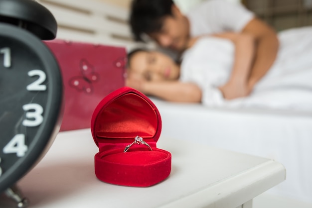 Wedding rings in a box on the bed