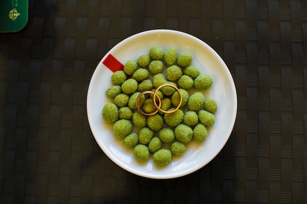 Wedding rings lie on the salty olives 