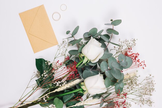 Wedding rings with bouquet of flowers