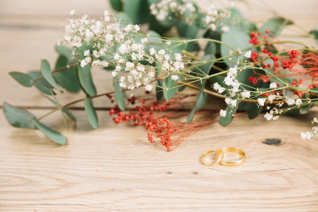 Wedding rings with bouquet of flowers