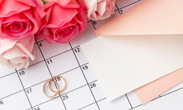 Wedding rings with flowers on calendar