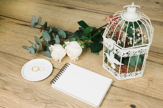 Wedding rings with flowers and a notebook