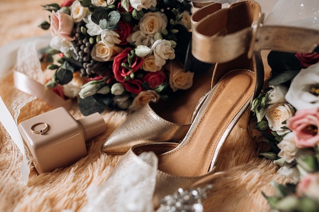 Wedding shoes for bride, wedding bouquets, perfume, precious engagement ring with gemstone