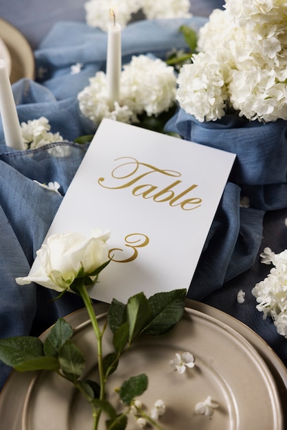 Free photo wedding table number and flowers assortment