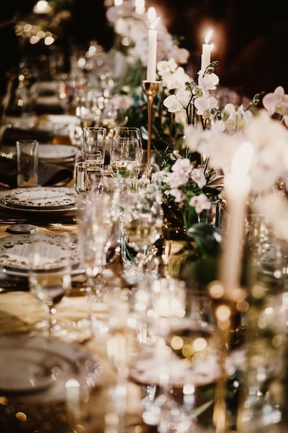 Wedding table with candles decorated with bouquets of flowers