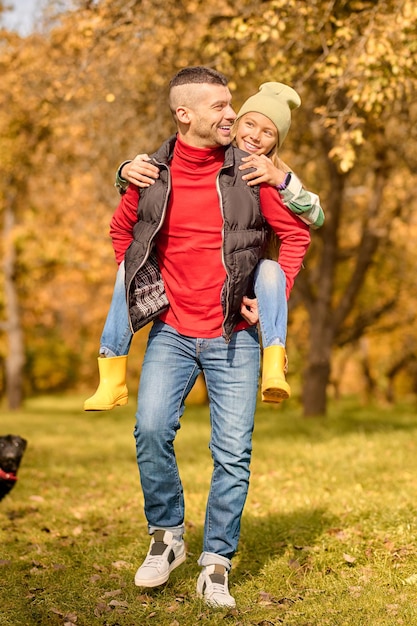 Weekend. Dad and daughter playing in the park and looking happy