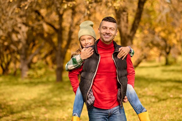 Weekend. Dad and daughter playing in the park and looking happy