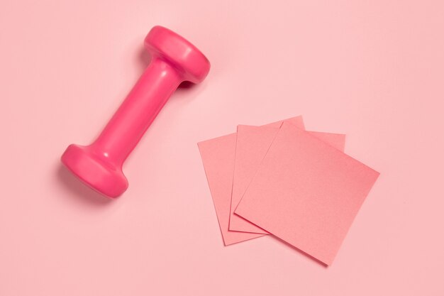 Weight and paper stickers. Monochrome stylish and trendy composition in pink color on studio wall. Top view, flat lay. Pure beauty of usual things around. Copyspace for ad. Fashion.