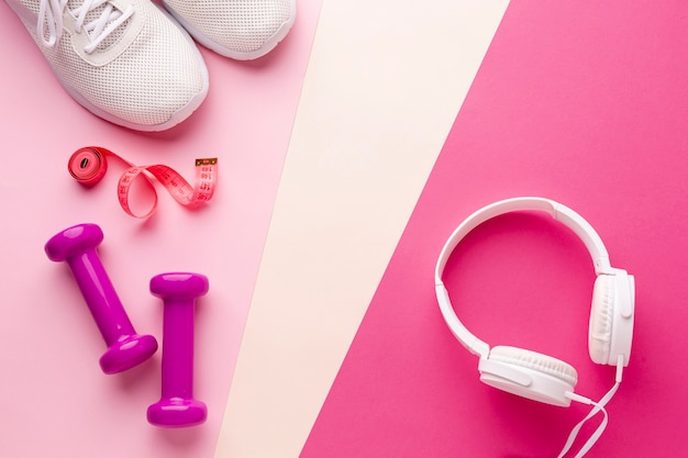 Free photo weights sneakers and headphones with copy space