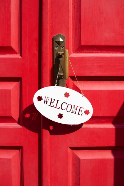 Welcome sign on red door