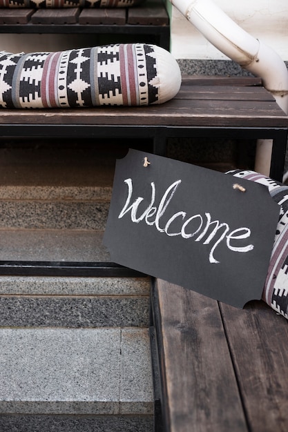 Free photo welcome sign on wooden stairs