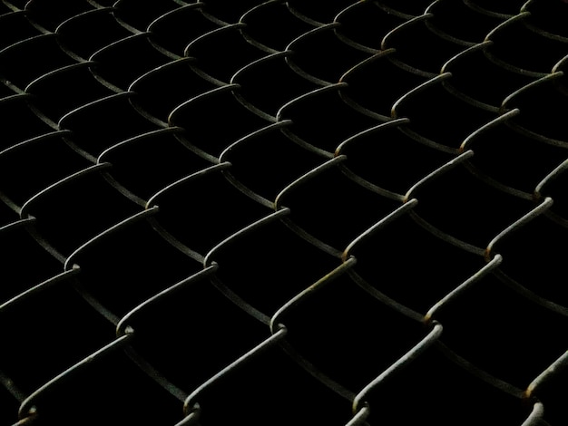 Welded mesh fence at night