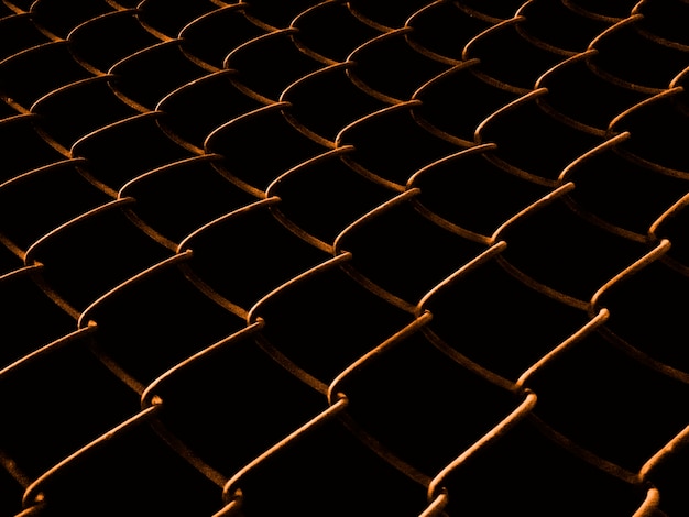 Welded mesh fence at night