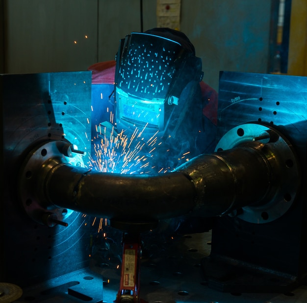 Welder working with steel