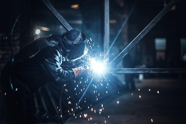 Welding work with metal construction at busy metal factory