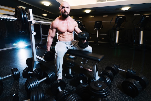 Well-built man lifting dumbbells