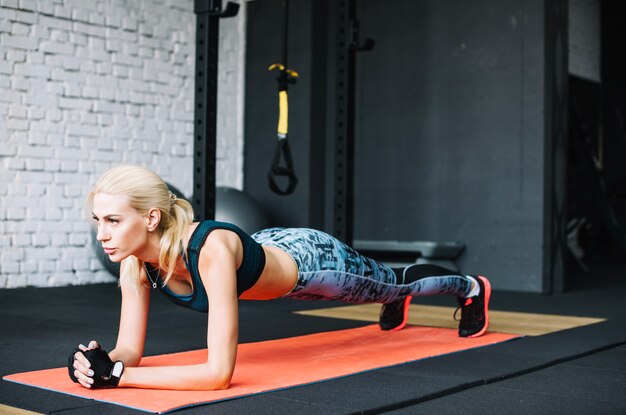 Well-built woman doing plank exercise