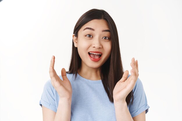 Well done congratulations Asian positive happy girl clap hands joyfully smiling broadly hear good news support friend enjoy great performans say bravo impressed stand white background entertained