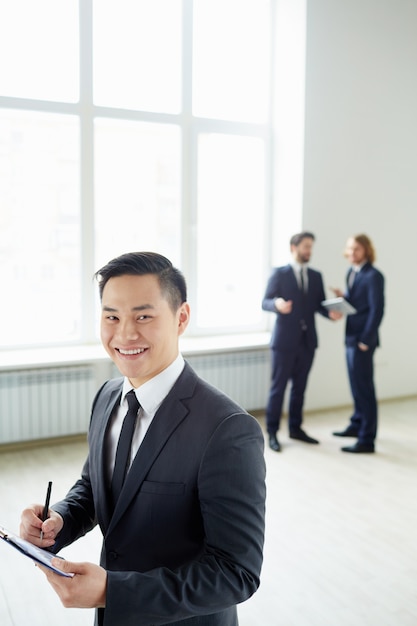 Well-dressed businessman holding a clipboard