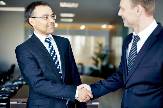 Well-dressed businessmen closing a deal