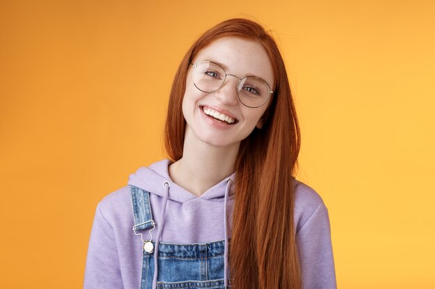 Wellbeing, lifestyle, people concept. Attractive friendly-looking smiling redhead young girl straight long natural ginger hair wearing glasses laughing happily enjoy nice relaxing cafe atmosphere