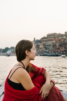 Western woman on a boat exploring the river ganges