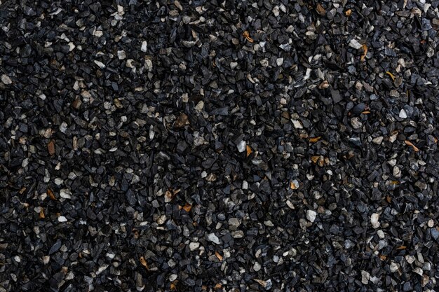 Wet dark granite gravel textured