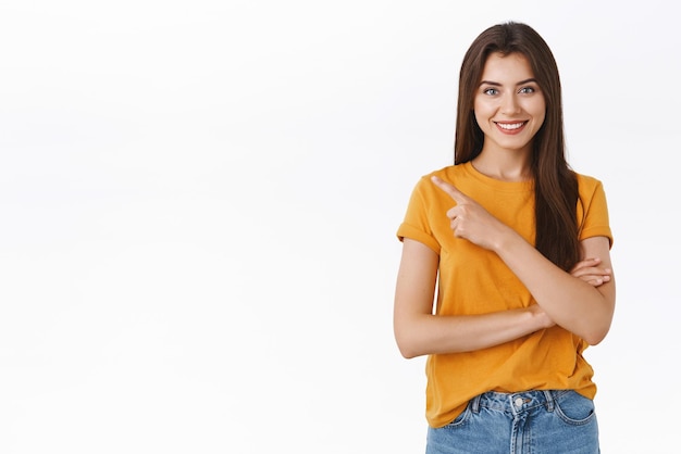 What are you waiting for sign up now Confident determined and happy friendlylooking attractive woman in yellow tshirt pointing upper left corner advice buy black friday sale smiling pleased