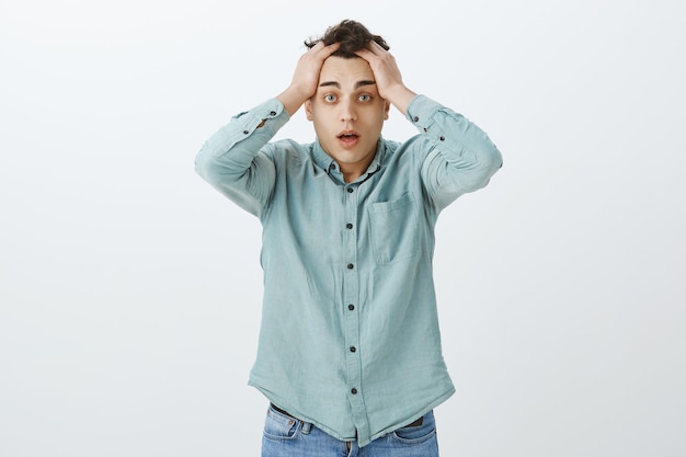 What have you done. Portrait of stunned displeased young man in casual shirt