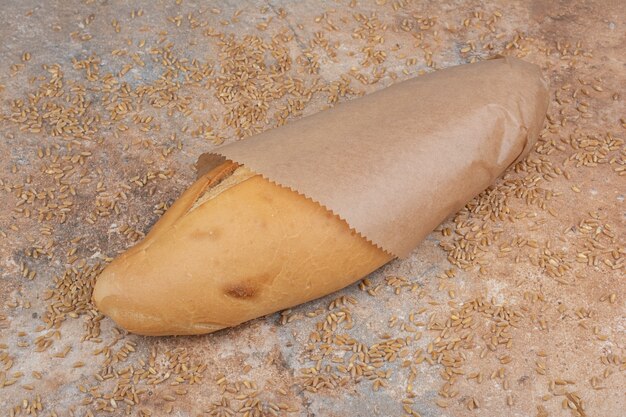 Wheat bread with barley on marble surface