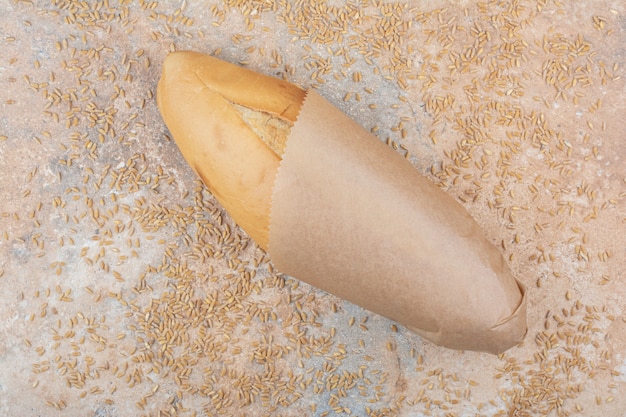 Wheat bread with barley on marble surface