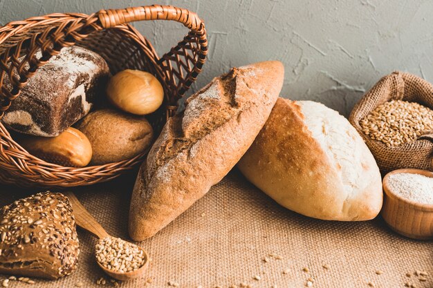 Wheat loaves with buns in basket