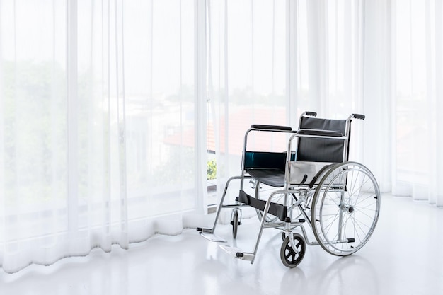 Wheelchair in empty room in nursing home or hospital