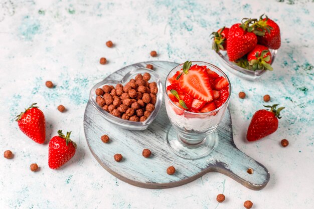 Whipped cream and strawberry trifle with honey and cereals.