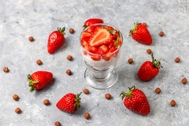 Whipped cream and strawberry trifle with honey and cereals.