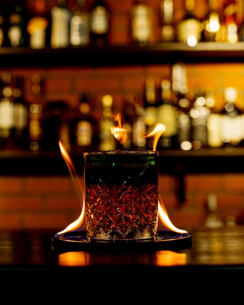 Free photo whiskey with fire on the table