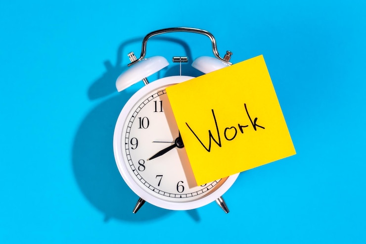 Бесплатный Фотография белый будильник и наклейка с надписью work на синем фоне