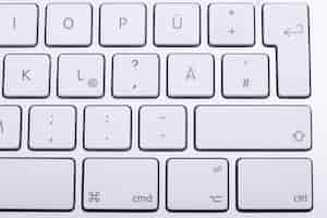 Free photo white aluminum keyboard in close up. technology and communication