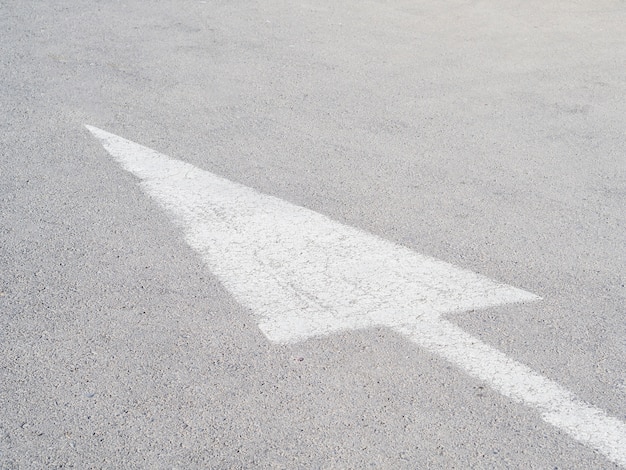 White arrow on asphalt