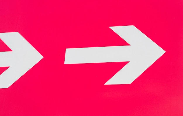 White arrows pointing right