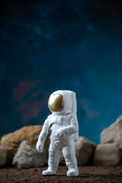 White astronaut around rocks on a moon blue  fantasy cosmic sci fi