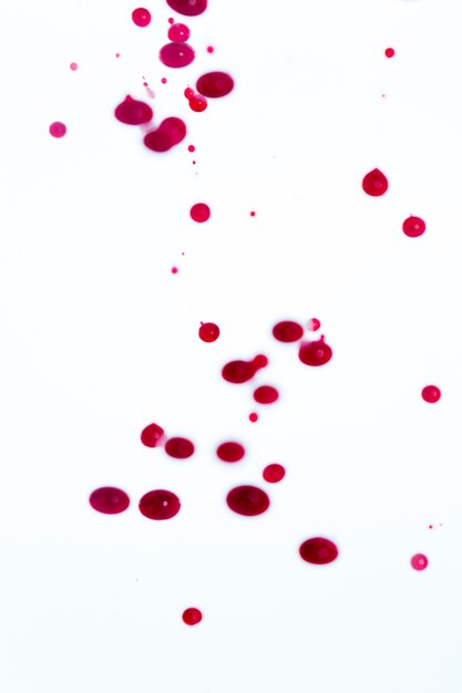 White background with abstract red drops