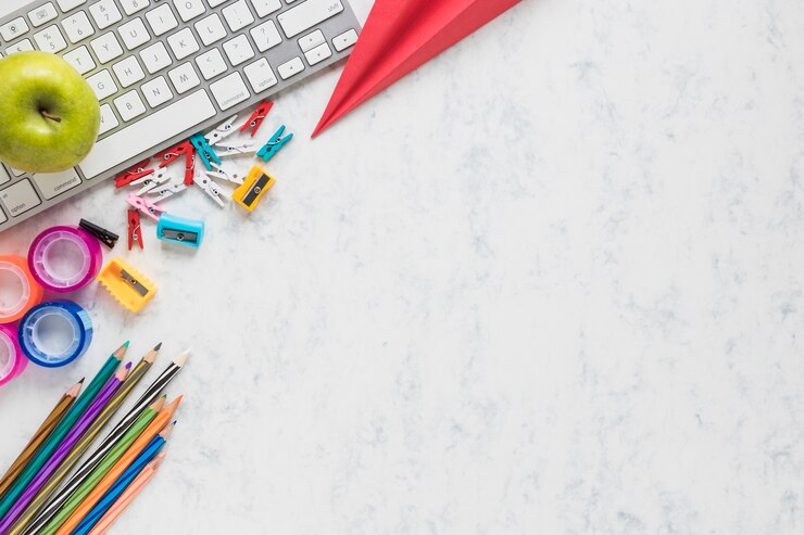 Free Photo white background with school supplies in corner