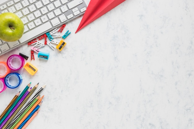 White background with school supplies in corner